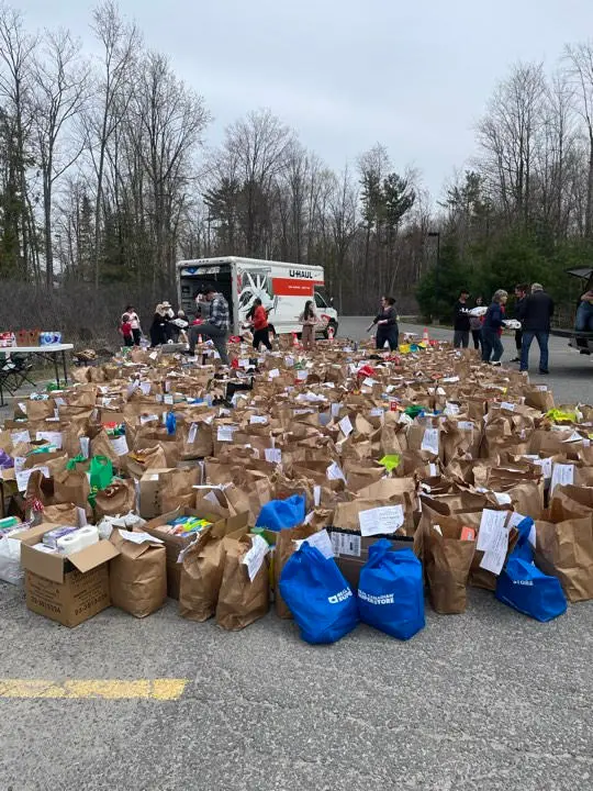 volunteers with large number of donations in bags